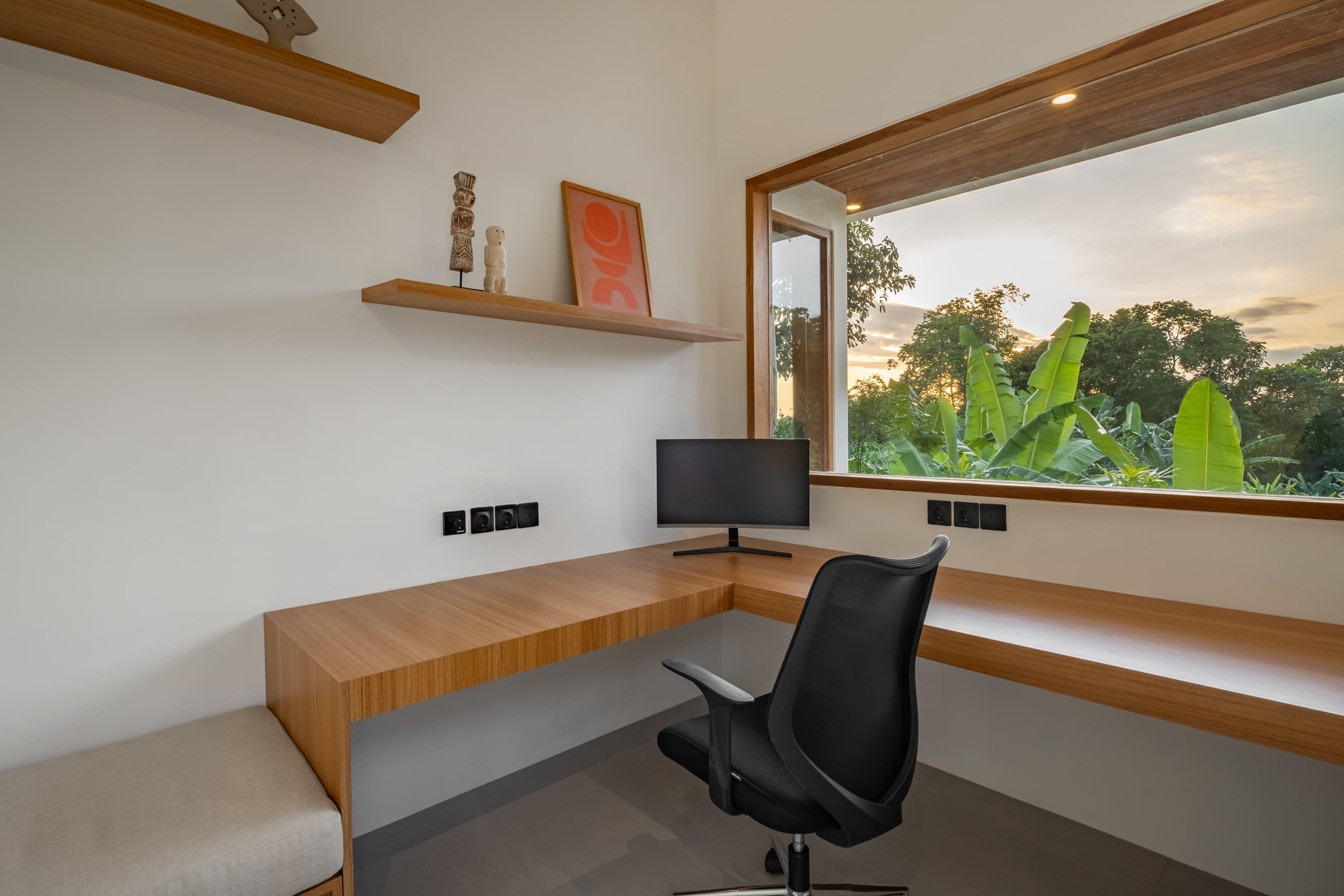 Workspace with curved monitor overlooking the jungle at Villa Vayu