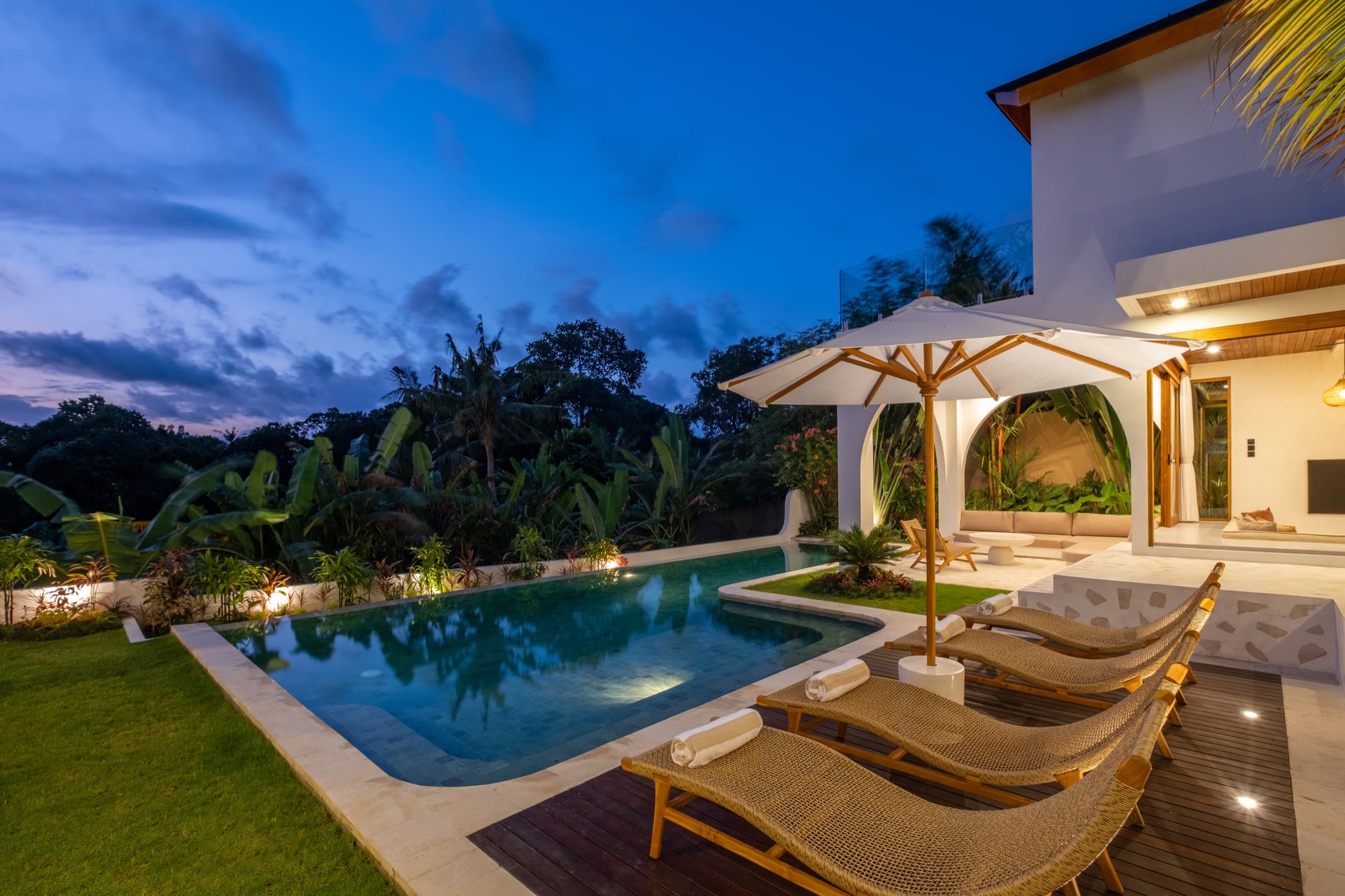 Outdoor lounge area at night at Villa Vayu