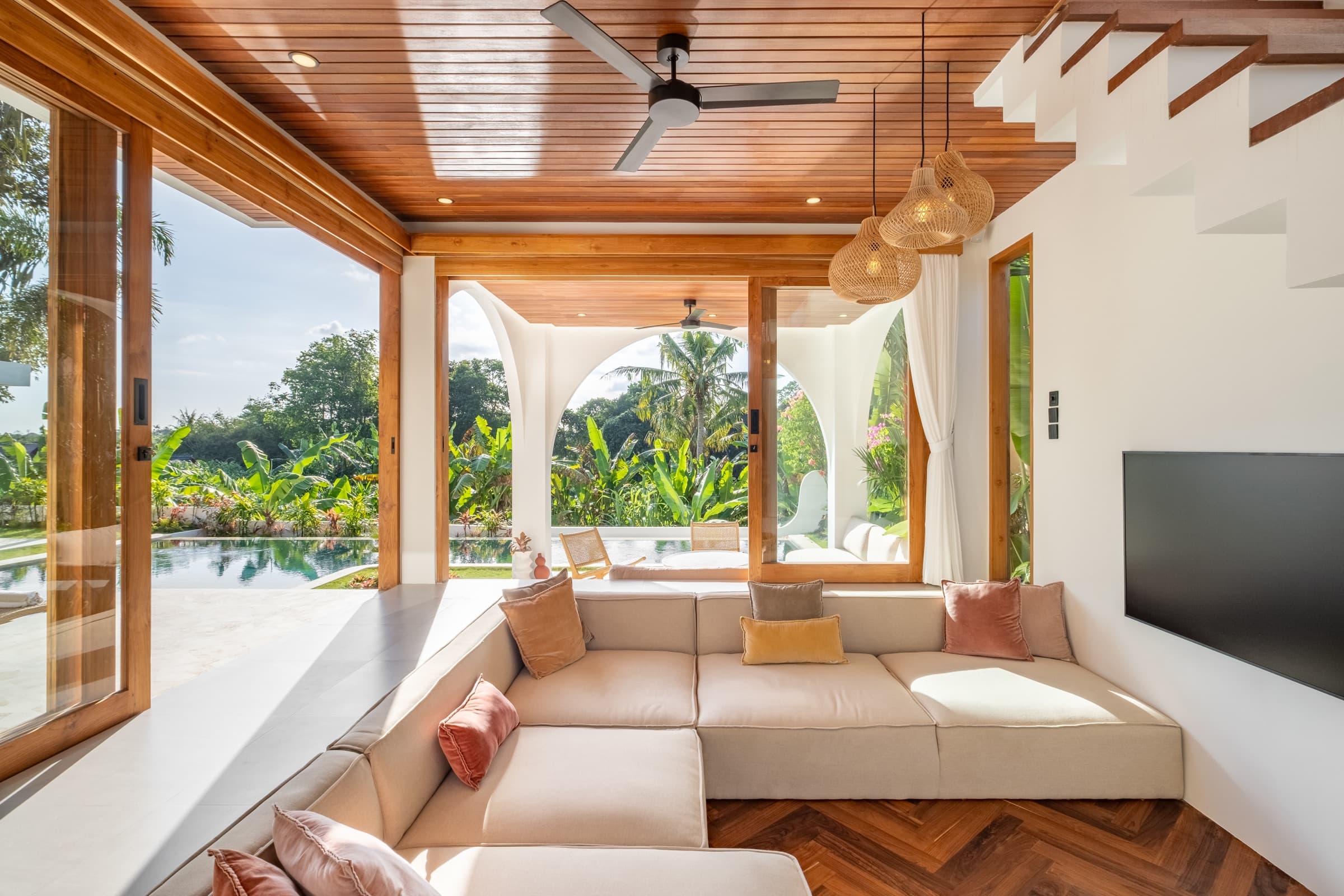 Living room opening out to the pool and garden at Villa Vayu